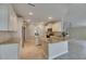 Modern kitchen with granite counters, white cabinets, and stainless steel appliances at 2017 S Pebble Beach Blvd, Sun City Center, FL 33573