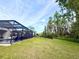 Lush backyard with screened in patio and pool, backing up to wooded area at 21422 Draycott Way, Land O Lakes, FL 34637