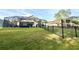 Expansive fenced backyard featuring a screened-in pool area with lounge seating at 21422 Draycott Way, Land O Lakes, FL 34637