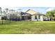 Wide shot of expansive backyard with iron fence and screened in patio and pool at 21422 Draycott Way, Land O Lakes, FL 34637