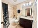 Bathroom featuring a shower-tub combo, updated vanity, and neutral color palette at 21422 Draycott Way, Land O Lakes, FL 34637