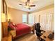 Bedroom with wood furniture, neutral walls, ceiling fan, and carpeted floors at 21422 Draycott Way, Land O Lakes, FL 34637