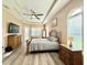 Spacious bedroom featuring wood flooring, ceiling fan, and a decorative dresser at 21422 Draycott Way, Land O Lakes, FL 34637