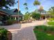 Community clubhouse with brick pavers, outdoor seating, and lush landscaping at 21422 Draycott Way, Land O Lakes, FL 34637