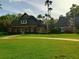Community clubhouse with lush green lawns, mature landscaping, and ample parking at 21422 Draycott Way, Land O Lakes, FL 34637