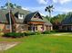 Well maintained clubhouse with stone accents, lush landscaping, and a green lawn at 21422 Draycott Way, Land O Lakes, FL 34637