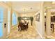 Traditional dining room featuring tile floors, a decorative mirror, and a chandelier at 21422 Draycott Way, Land O Lakes, FL 34637