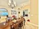 Traditional dining room boasting a polished table, upholstered chairs, and decorative chandelier at 21422 Draycott Way, Land O Lakes, FL 34637