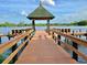 Waterfront community wooden dock on the lake with gazebo and relaxing seating at 21422 Draycott Way, Land O Lakes, FL 34637