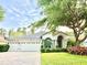 Attractive single-story home boasts a three-car garage, manicured lawn, and welcoming landscaping at 21422 Draycott Way, Land O Lakes, FL 34637
