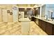 Well-equipped kitchen with stainless steel appliances, granite countertops and dark wood cabinets at 21422 Draycott Way, Land O Lakes, FL 34637