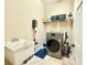 Laundry room with a wash basin, modern dryer, and overhead storage at 21422 Draycott Way, Land O Lakes, FL 34637
