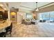 Bright living room featuring a ceiling fan, modern lighting, and sliding glass doors to the pool area at 21422 Draycott Way, Land O Lakes, FL 34637