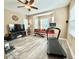 Open living area featuring a window seat, neutral paint, ceiling fan, and exercise equipment at 21422 Draycott Way, Land O Lakes, FL 34637