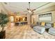 Open concept living room with modern decor, ceiling fan, and access to the kitchen and outdoor areas at 21422 Draycott Way, Land O Lakes, FL 34637