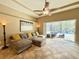Living room with tile floors, ample seating, and a view of the screened-in pool and backyard at 21422 Draycott Way, Land O Lakes, FL 34637