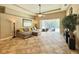 Living room featuring comfortable seating and an open view of the screened-in pool and patio at 21422 Draycott Way, Land O Lakes, FL 34637