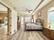 Main bedroom featuring a king bed, ensuite bath and plenty of natural light at 21422 Draycott Way, Land O Lakes, FL 34637