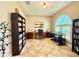 Bright office featuring a large window, desk, keyboard, and built-in bookshelves at 21422 Draycott Way, Land O Lakes, FL 34637