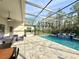 Screened-in pool area with water feature and plenty of space for lounging and entertaining outdoors at 21422 Draycott Way, Land O Lakes, FL 34637