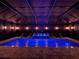 Beautiful indoor pool with integrated water feature, lounge chairs, and ambient lighting at 21422 Draycott Way, Land O Lakes, FL 34637