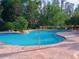 Large community pool with brick paver deck and tropical landscaping at 21422 Draycott Way, Land O Lakes, FL 34637