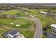 Aerial view featuring a home near a golf course with lush greens and sand traps at 2190 Fairway S Ave, St Petersburg, FL 33712