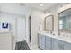 Bright bathroom featuring double sink vanity with wood-framed mirrors and modern fixtures at 2190 Fairway S Ave, St Petersburg, FL 33712