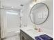 Modern bathroom featuring a vanity with a round mirror and a shower/tub combination at 2190 Fairway S Ave, St Petersburg, FL 33712