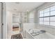 Bright bathroom featuring a shower with glass surround next to a soaking tub at 2190 Fairway S Ave, St Petersburg, FL 33712