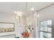 Close-up of an elegant, gold chandelier, with neutral walls and natural light streaming through windows at 2190 Fairway S Ave, St Petersburg, FL 33712