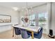 Bright dining room featuring a stylish chandelier, large windows, and modern decor at 2190 Fairway S Ave, St Petersburg, FL 33712