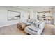 Bright living room featuring a comfortable gray sectional sofa, modern art, and hardwood floors that lead to a contemporary kitchen at 2190 Fairway S Ave, St Petersburg, FL 33712