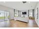 Bright living room featuring a comfy sofa, large windows, and sliding glass doors at 2190 Fairway S Ave, St Petersburg, FL 33712