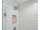 Close-up of shower stall featuring a rainfall shower head and recessed shelf at 2190 Fairway S Ave, St Petersburg, FL 33712