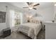 Bedroom with a window view, ceiling fan, and stylish decor at 233 Cascade Bend Dr, Ruskin, FL 33570