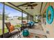Relaxing covered lanai with comfortable seating, ceiling fans, and views of the backyard at 233 Cascade Bend Dr, Ruskin, FL 33570