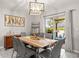 Dining room with modern light fixture and sliding glass doors to the patio at 233 Cascade Bend Dr, Ruskin, FL 33570