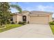 Charming single-story home features a well-maintained lawn, mature trees, and a two-car garage at 233 Cascade Bend Dr, Ruskin, FL 33570
