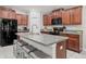 Well-equipped kitchen with stainless steel appliances, granite countertops, and a breakfast bar at 233 Cascade Bend Dr, Ruskin, FL 33570