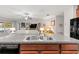 Open kitchen featuring granite countertops, stainless steel sink, and views into the spacious living area at 233 Cascade Bend Dr, Ruskin, FL 33570