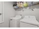 Laundry room with a washer, dryer, and storage shelves at 233 Cascade Bend Dr, Ruskin, FL 33570