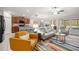 Open-concept living room with natural light, stylish furniture, and an adjacent modern kitchen at 233 Cascade Bend Dr, Ruskin, FL 33570