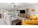 Bright living room with a ceiling fan, entertainment center, and a comfortable seating area at 233 Cascade Bend Dr, Ruskin, FL 33570