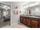 Elegant bathroom with double vanity, granite countertops, and ample lighting at 233 Cascade Bend Dr, Ruskin, FL 33570