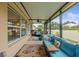 Covered screened patio featuring comfortable seating and outdoor decor at 233 Cascade Bend Dr, Ruskin, FL 33570