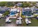 Stunning aerial view of waterfront homes with private docks and boat lifts on a sunny day at 2501 S Dundee St, Tampa, FL 33629
