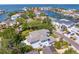 Aerial view of a luxurious home with a pool, surrounded by lush greenery and waterfront views at 2501 S Dundee St, Tampa, FL 33629