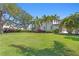 Large backyard with lush lawn and beautiful landscaping at 2501 S Dundee St, Tampa, FL 33629