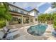 Backyard with a large pool and a covered patio with outdoor seating at 2501 S Dundee St, Tampa, FL 33629